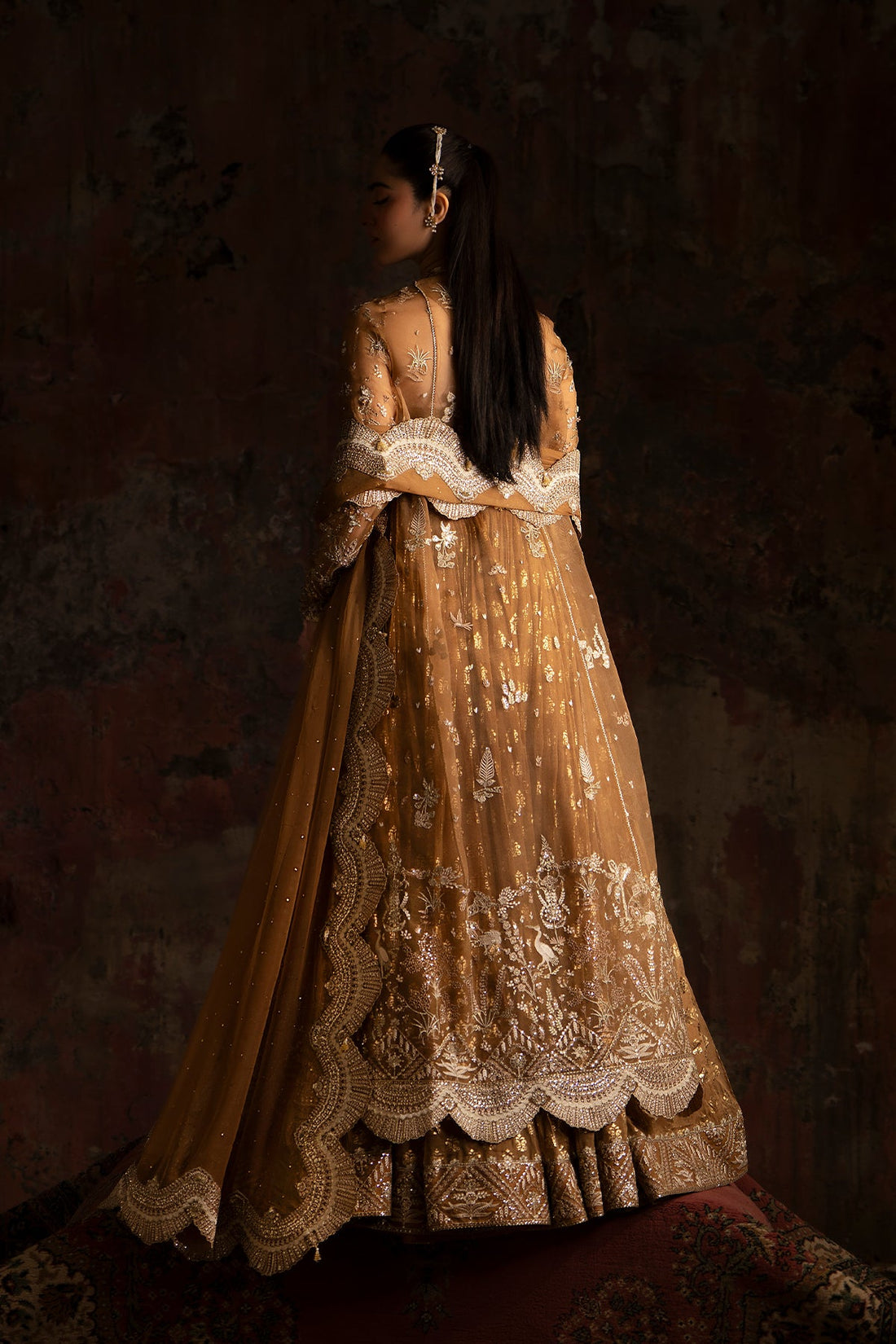 gold pakistani dress Gold & Red Bridal Dress Pakistani in Lehenga Gown Style is an epitome of tradition and royalty to have a magnificent appearance at the wedding. Hand-crafted embellishments and golden work on this